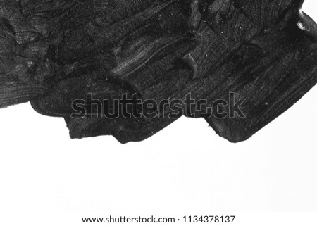 Black brush strokes on white paper isolated. Black brush strokes oil paints on white paper. Isolated on white background. Abstract creative white black background