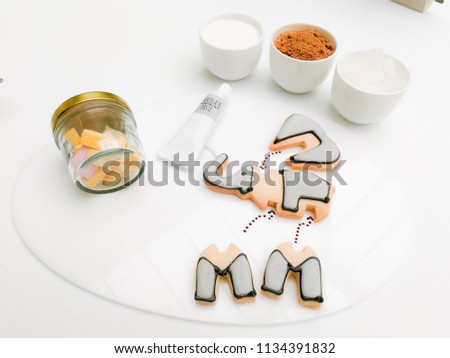 kid cookies, a serving plate of cute 3D puzzle elephant cookies with Chocolate-hazelnut paste, Marshmallow and topping suger rock,brown suger,white suger,  
