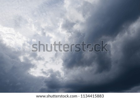 Background blue sky with gray cumulus clouds