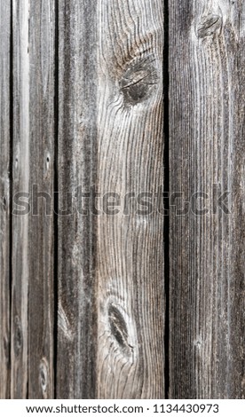 Wooden fence panels with textured grains and patterns.