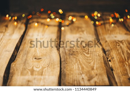 background image. wallpapers on the desktop in the New Year style. Wooden photo background with garlands and bokeh on black. Christmas tree toys. new year, holiday, fun.