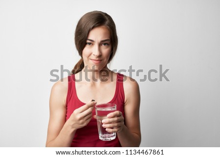  woman sick holds a glass of water                              