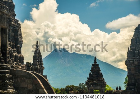 Ancient mystical old Hindu Prambanan temple with Merapi Vulcano in background near Yogyakarta on Java island Indonesia