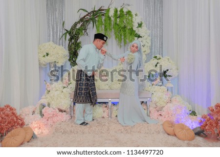Indoor shooting for Malay wedding, the bride and groom Malay traditional  cloth in solemnization ceremony . Happy & Family Concept