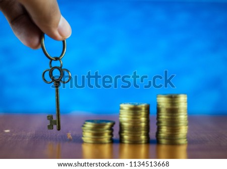 House key and stack coins. Key success concept