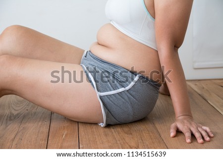 women fat with belly fat on white background Royalty-Free Stock Photo #1134515639