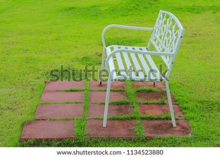 White chair on the grass with soft focus