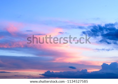 Dramatic black clouds and blue sky at sunset.