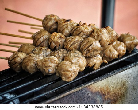 Many meatballs are large and cooked it is looks are colorful and look delicious placed on the grill.