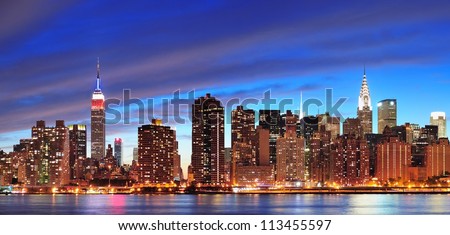 New York City Manhattan midtown panorama at dusk with skyscrapers illuminated over east river