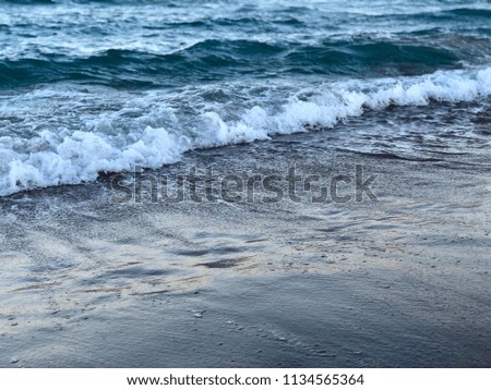waves of sea water on the sand