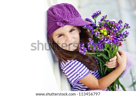 Picture of a little girl with flowers in their hands