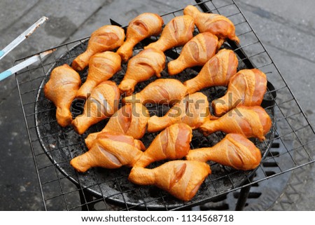 Roasted chickens on charcoal stove., Street food in Thailand.