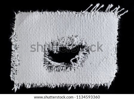 A piece of white canvas on a black background