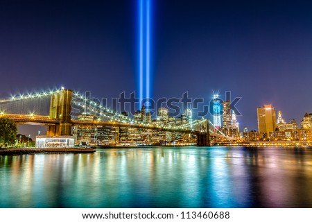 911 Lights over NYC - September eleventh memorial beams from over Brooklyn Bridge in Manhattan across the East River at night