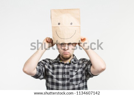 Sad men taking off happy paper mask on white background