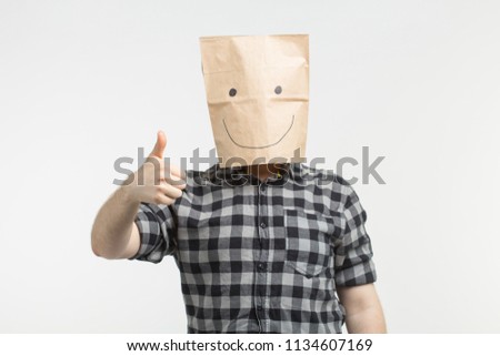 men in happy paper bag mask with thumbs up on white background