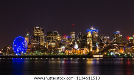 Long exposure shot of Montreal skyline and St Lawrence River illuminated at night, Quebec, Canada