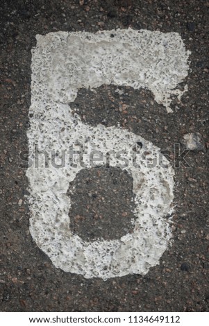 Number 6 painted on the asphalt