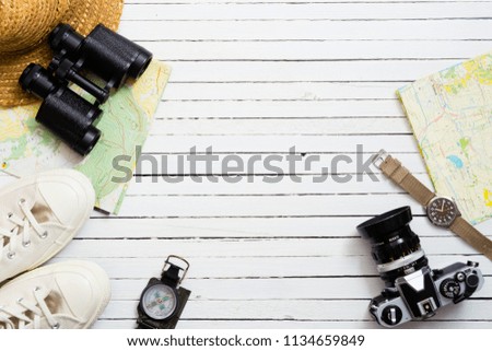 travel accessories on white wooden background