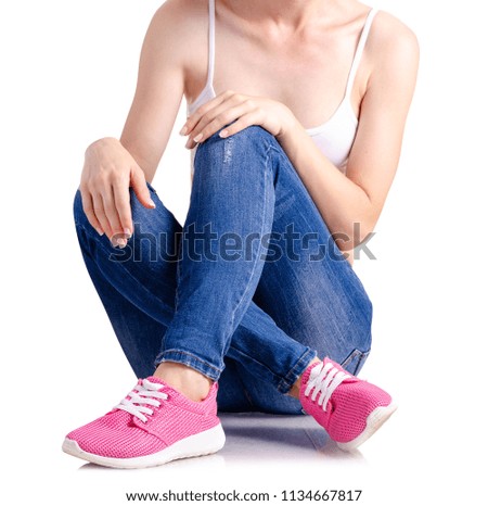 Woman denim sneakers on white background isolation