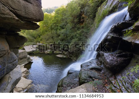 Small waterfall in the mountain forest near village Ripit i Pruit, Catalonia, Spain Royalty-Free Stock Photo #1134684953