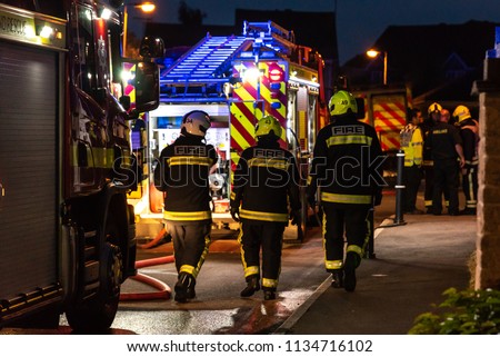 Fire Brigade in action fighting an ambulance fire Royalty-Free Stock Photo #1134716102