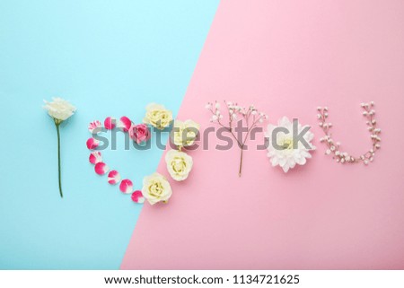 Inscription I Love You by flowers on colorful background