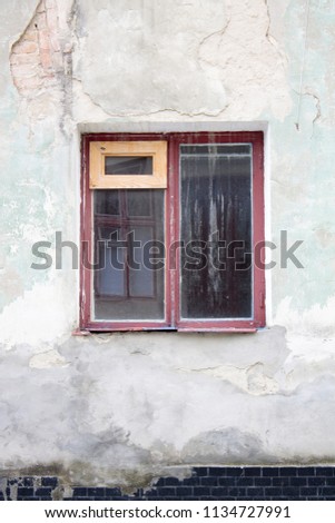 Photo of old single window on old wall
