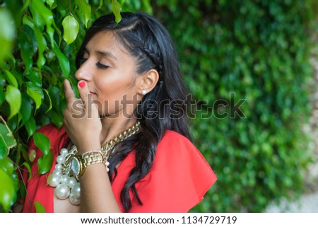 young woman smelling the plants