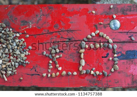 child plays with pebbles, composes from stones pictures, concept family, house, future