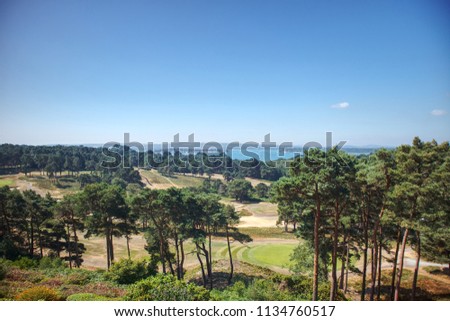 A panoramic view of Sandbanks, the Purbeck Hills, Brownsea Island and a golf course from Poole on the Dorset Coast in England, UK in the summer.