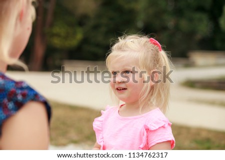 Little girl talking to her mom