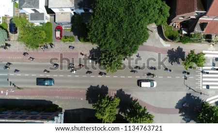 Aerial top down photo of busy streets filled with small motorcycles and mopeds in developing countries motorcycles are considered utilitarian due to lower prices and greater fuel economy