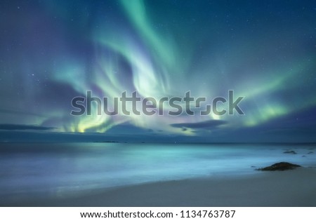 Northen light above ocean. Beautiful natural landscape in the Norway Royalty-Free Stock Photo #1134763787