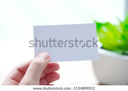 Businessman hand holding blank white business card with copy space for text, business mock up background concept 