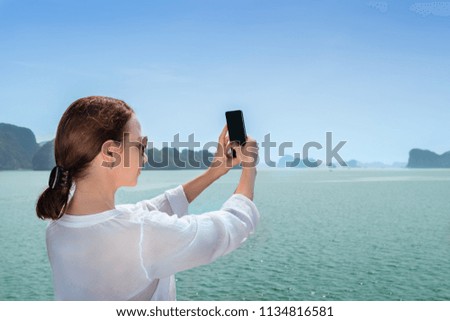 Brunette woman travelling on boat and making selfie