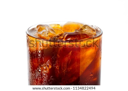 close up macro photo of ice Americano coffee in glass that look cool and refreshing to make you thirsty.Flash light reflex with Americano glass and water drop to make it look cold. Royalty-Free Stock Photo #1134822494