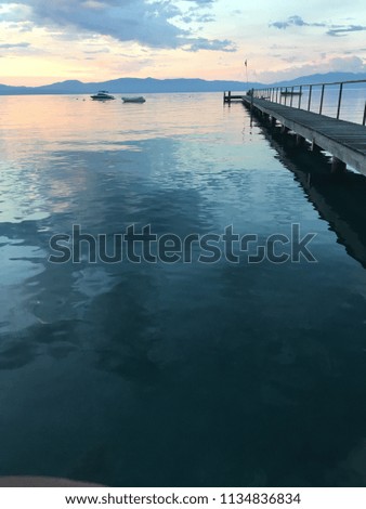 Colorful sunrise over pier with boats at Lake Tahoe in California, United States
