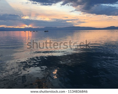 Colorful sunrise over pier with boats at Lake Tahoe in California, United States