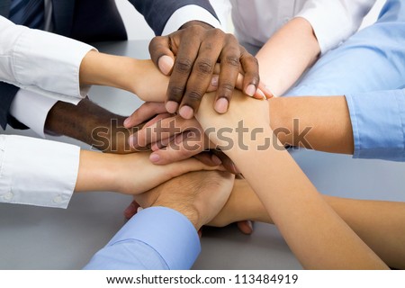 International  business team showing unity with their hands together Royalty-Free Stock Photo #113484919