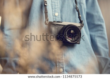 Young photographer with photos camera