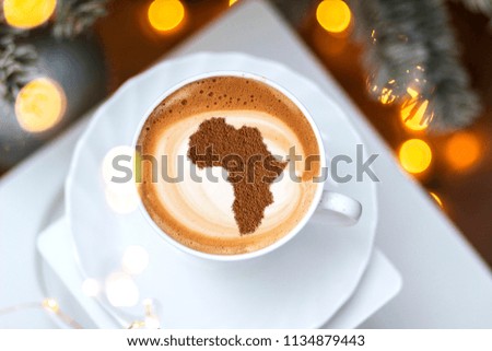 cup of coffee cappuccino with a picture of Africa on milk foam