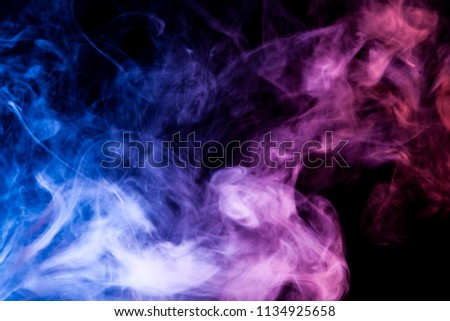 Cloud of blue and purple  smoke on a black isolated background. Background from the smoke of vape
