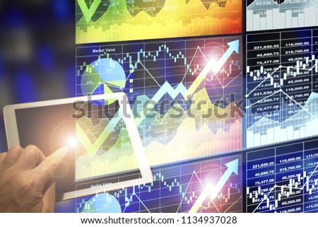 Businessman pressing power at the spot of bright light on dark blue digital background to connect 
and control big data internet online at night futuristic background.
