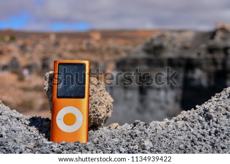 Conceptual Photo Picture of a Music Player Object in the Dry Desert
