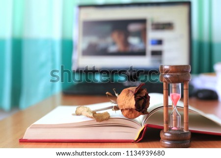 Close-up of dried roses on open book in office selective focus and shallow depth of field