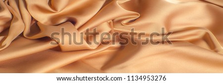Texture pattern. The color of coffee with milk is a silk fabric. Milk silk is the term given to silk, which is derived from milk. fabric with a rich velvety texture and feels very luxurious In design