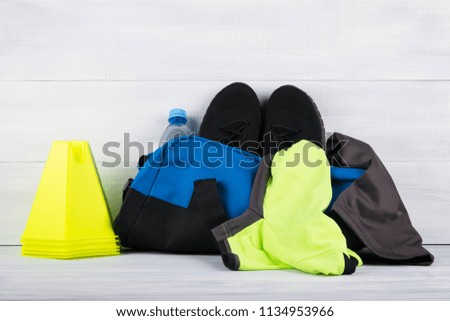 a set of things to play sports in a blue bag on a light background