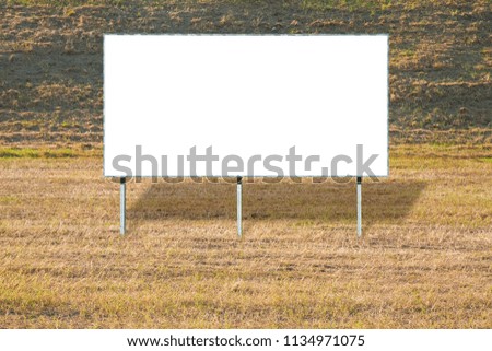 Blank advertising billboard in a field of dried grass - image with copy space